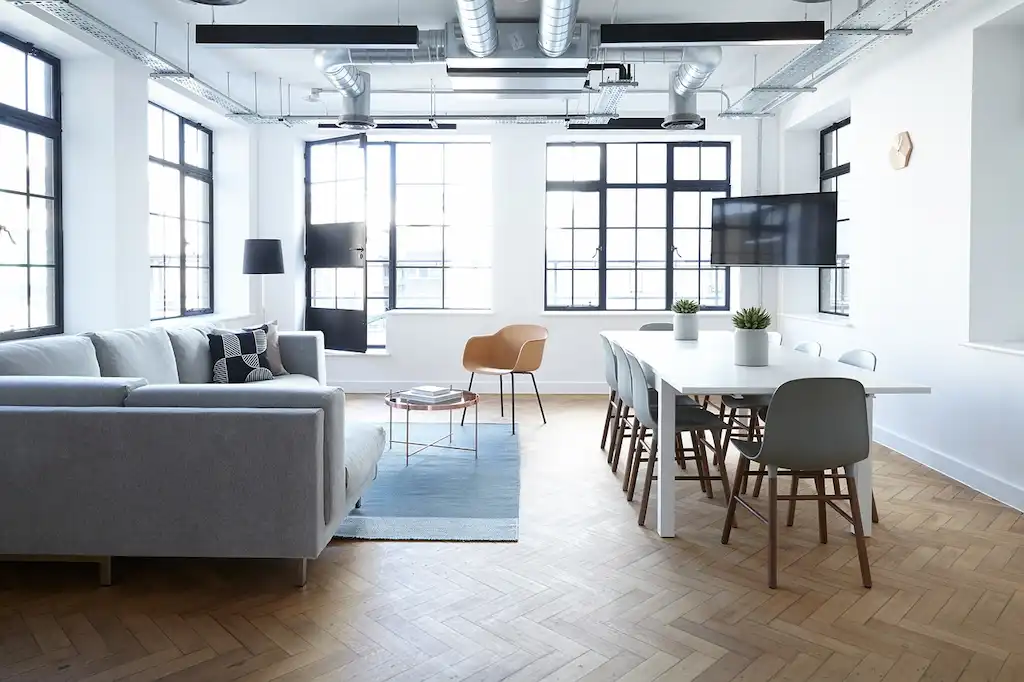 Deserted, bright office area with sofa and table symbolising potential for business consultancy services in Haarlem