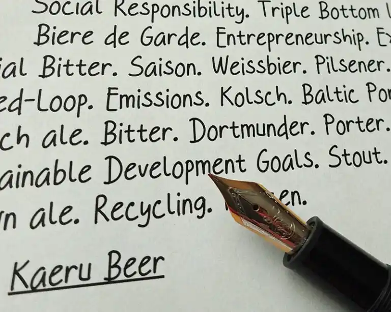 A fountain pen on a sheet of paper containing beer and sustainability words written by a beer and beverage industry consultant.